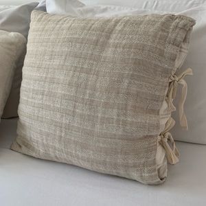 Decorative tan pillow with ties